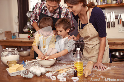 Image of Family, smile and children baking, learning or happy boys bonding together with parents in home. Father, mother and kids cooking with flour, food and teaching brothers how to make dessert in kitchen