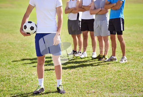 Image of Person, team and hand holding soccer ball for game, training and competition with fitness. People, group and football player with coach, captain or leader for sports, exercise or workout for contest