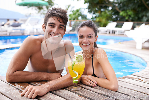 Image of Swimming pool, cocktail and couple with portrait, summer and weekend break with vacation and honeymoon. Sunshine, man and woman with tropical drink and love with holiday and luxury with celebration