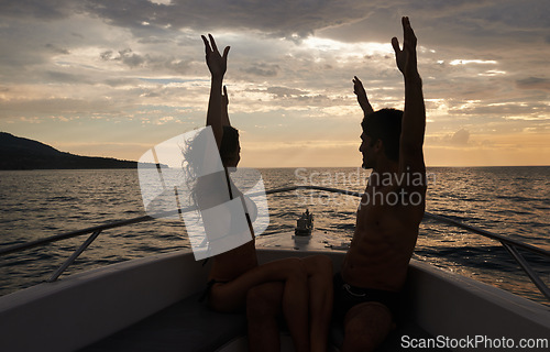 Image of Couple, freedom and sunset on boat with silhouette, happy with vacation and travel to Italy for the ocean and fresh air. Romantic adventure for love, bonding and excited with arms raised in transport