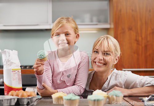 Image of Happy, mom and child with cupcake in kitchen and learning about baking together in home to relax. Family, bonding and kid smile with mother, excited for eating cake, sweets or enjoy food in house