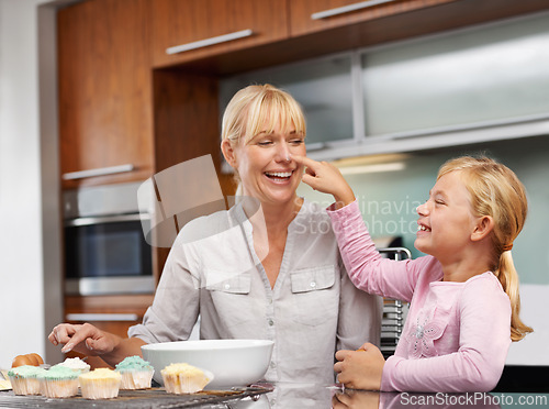 Image of Mother playing, flour or girl baking in kitchen or happy family with an excited child learning cupcake recipe. Home, daughter or fun mom with muffin, help or smile for teaching kid for development