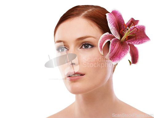 Image of Skincare, flower and woman in studio with natural, organic and beauty face routine for wellness. Cosmetic, mockup and person with floral plant for facial dermatology treatment by white background.