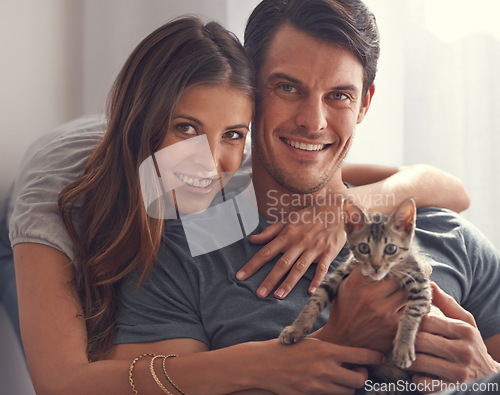 Image of Couple, kitten and portrait in home on sofa with hug for love, bonding or care for pet in living room. People, man and woman with kindness, embrace or pride for baby cat in lounge for animal adoption
