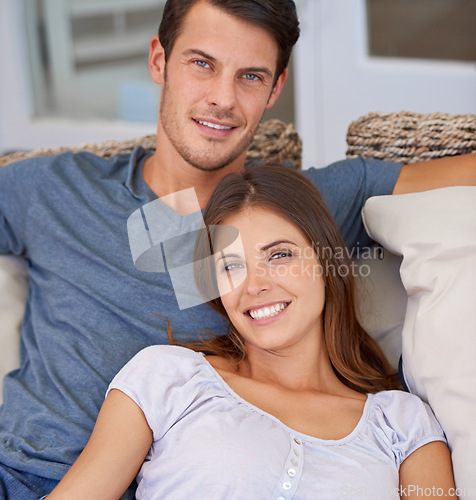 Image of Happy, love and portrait of couple on sofa for bonding, relationship and relax together. Home, dating and man and woman embrace, hug and smile on couch for support, care and affection in living room