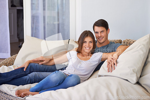 Image of Smile, portrait and couple relaxing on sofa for bonding in living room at apartment together. Happy, resting and young man and woman laying on couch for romance and marriage in lounge at modern home.