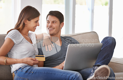 Image of Happy couple, laptop and sofa with credit card for online shopping, payment or purchase in living room at home. Man and woman with smile or debit on computer for ecommerce, banking or transaction