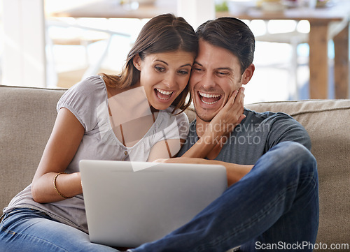 Image of Happy couple, laptop and sofa with good news for winning, giveaway or surprise in living room at home. Excited man and woman with smile on computer in celebration for promo, deal or discount at house