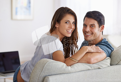 Image of Happy couple, portrait and relax on sofa for bonding, holiday or weekend together at home. Face of young man and woman with smile for love, comfort or relationship on sofa in living room at house