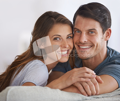 Image of Happy couple, face and portrait with love in relax on sofa for bonding, holiday or weekend together at home. Young man and woman with smile for support, care or relationship in living room at house