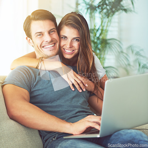 Image of Laptop, smile and woman embrace man on sofa networking on social media, website or internet. Happy, love and female person hugging husband reading online blog with computer in living room at home.