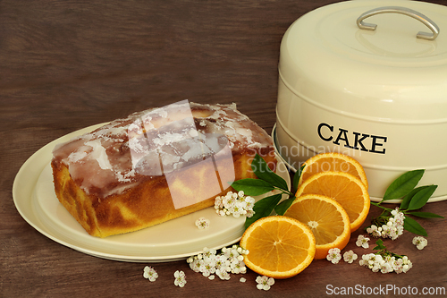 Image of Orange Drizzle Cake with Fruit and Blossom Flowers