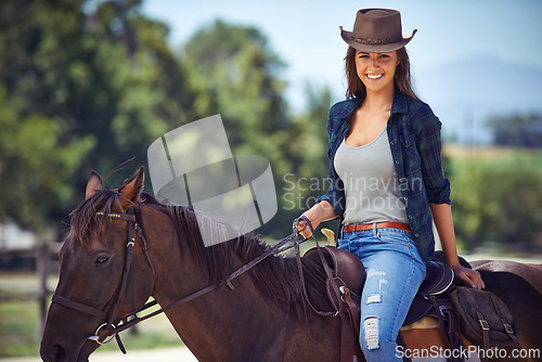 Image of Woman, portrait and horse riding on countryside farm as equestrian for adventure sport, training or cowboy hat. Female person, saddle and western farming in Texas or environment, outdoor or stable