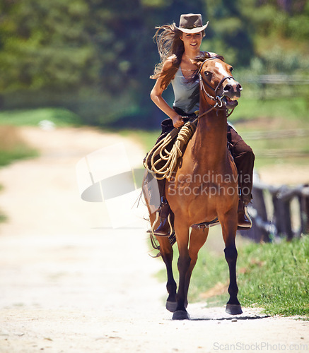 Image of Happy woman, countryside and cowgirl with horse for ride, journey or outdoor adventure in nature. Female person or western rider with hat, saddle and animal stallion or riding pet at ranch or farm