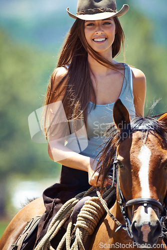 Image of Happy woman, portrait and cowgirl with horse in countryside for ride, journey or outdoor nature adventure. Female person or western rider with hat, saddle and animal stallion at ranch, farm or stable