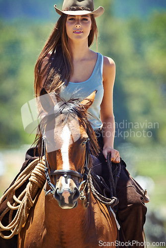 Image of Woman, portrait and cowgirl with horse in countryside for ride, journey or outdoor adventure in nature. Female person or western rider with hat, saddle and animal stallion at ranch, farm or stable