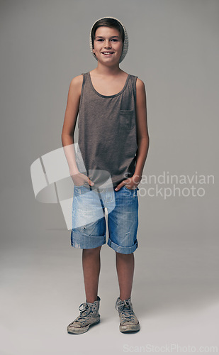 Image of Happy boy, portrait and fashion with style in denim shorts or jeans on a gray studio background. Male person, child or teenager with summer clothing or cool stylish outfit with winter cap on mockup