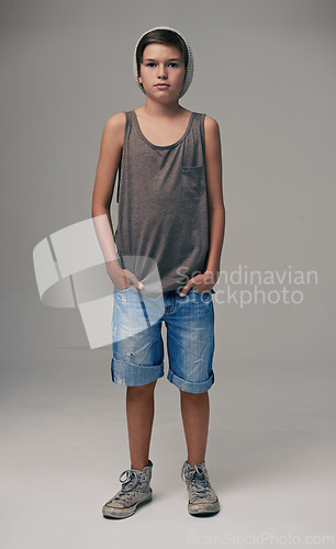 Image of Young boy, portrait and fashion with style in denim shorts or jeans on a gray studio background. Male person, child or teenager with summer clothing or cool stylish outfit with a beanie on mockup