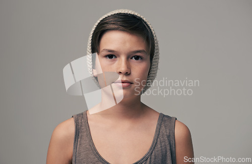 Image of Boy, beanie and fashion in studio for portrait with teenager, edgy and aesthetic by background. Kid, model and hat with trendy style, face and pride for clothes with confidence for punk outfit