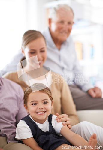 Image of Girl, child and family with happiness on sofa for healthy development, security or comfort in apartment. Face, mother and grandfather with kid, smile and bonding for parenting and love in house