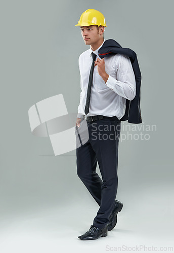 Image of Man, engineer and thinking in studio for project for architect industry, maintenance or hard hat. Male person, thoughts and labor employee on grey background or construction, jacket or mockup space
