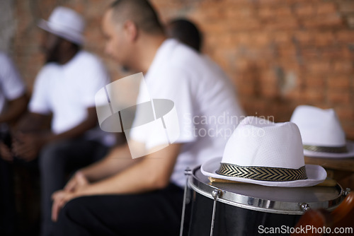 Image of Band, relax and music with percussion drums on stage, rhythm and men with talent in group. Friends, hats and practice performing in team as professional musician and bonding together for carnival