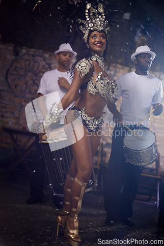 Image of Samba, woman and dancing to band at carnival in rio de janeiro for brazilian festival with feather costume or smile. Person, dancer or night with energy, fashion or music for culture or outdoor event
