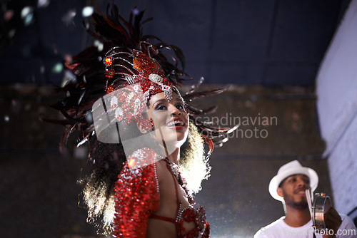 Image of Night, woman or dancer with samba at carnival in rio de janeiro for brazilian festival with feather costume or smile. Person, face or party with dancing, fashion or music for culture or outdoor event