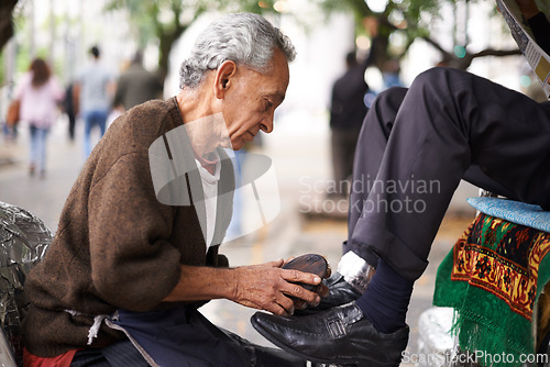 Image of Shoe cleaner, elderly man person and shining feet, small business owner and professional on busy street. Mature, senior male and experienced worker from Puerto Rico, working with brush in city