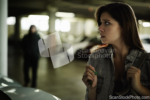 Image of Female person, suspicious and parking lot with anxiety, worried and stressed for safety and concern. Woman, in danger and scared with backpack, terror and afraid for scary place and living in fear