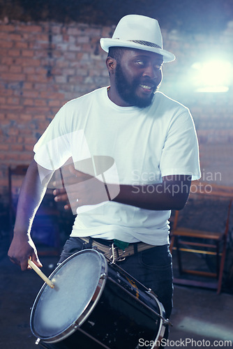 Image of Smiling, black man and playing drum or music for event, concert with percussion and entertainment. Festival, performance and beats on rhythm for band of a creative on stage with white shirt and hat