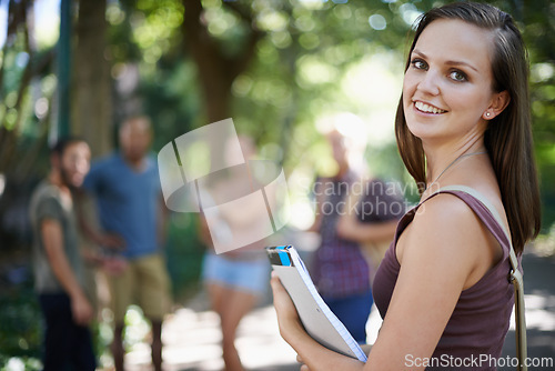 Image of Portrait, student and woman with smile, campus and outdoor with education and university. Face, person or girl with books or college with knowledge or sunshine with learning or happy with scholarship