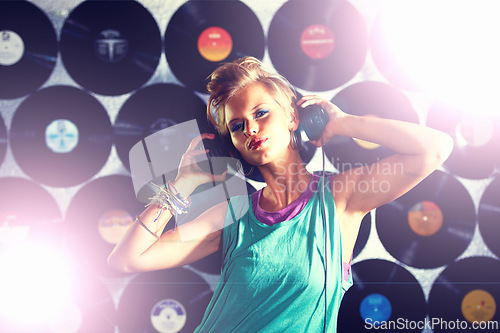 Image of Nightclub, DJ and portrait of woman with headphones for listening to music with vinyl on wall. Techno, rave and musician in light at concert stage and mix sound for party event entertainment at night