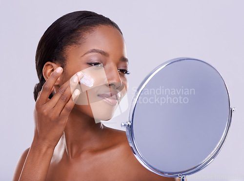Image of Mirror, cream and black woman for beauty and dermatology, cosmetic product and shine on white background. Skincare, lotion or sunscreen for moisturizer, antiaging with skin and facial in studio