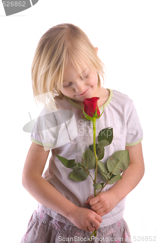 Image of Child Smelling Rose