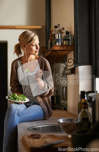 Image of Thinking, woman and eating salad in kitchen at home, nutrition and fresh leafy greens for healthy diet. Food, bowl and hungry person with vegetables, lunch or dream of organic vegan meal for wellness