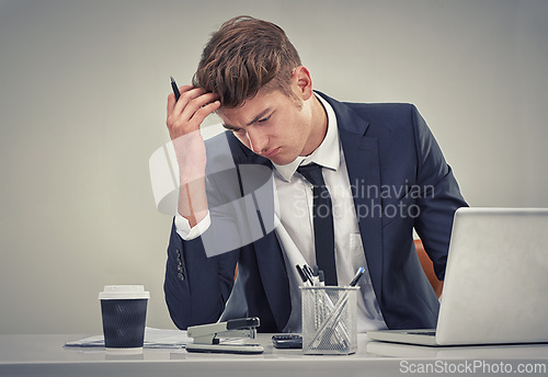 Image of Man, accountant and laptop with stress for finance, fail or recession in studio with thinking for solution. Person, audit or budget with anxiety for low revenue, profit and frustrated with results