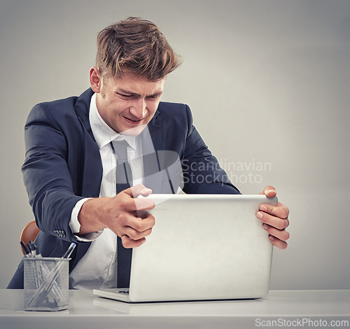 Image of Man, accountant and frustrated with laptop for finance, fail and recession in studio with anger for loss. Person, audit and budget with anxiety for low revenue, profit and depression with results