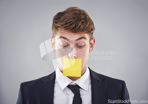 Image of Business man, sticky note and mouth in studio for silence, reminder and thinking by white background. Person, employee or corporate workout with paper on lips for compliance, censorship and quiet
