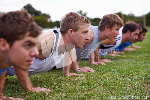 Image of Group, men and field for push up with exercise, training and health with friends for sport, challenge or wellness. People, athlete and teamwork with fitness, workout and together on grass for muscle
