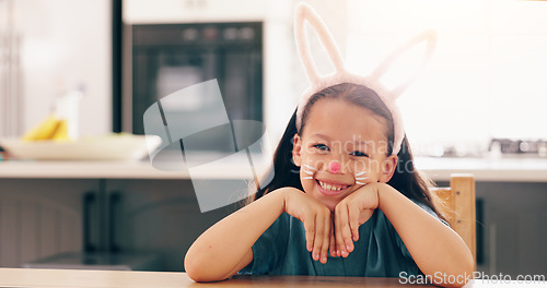 Image of Girl, child and bunny ears for portrait in home to smile for culture, holiday or festive celebration. Kid, face paint and art for rabbit, Easter and happy for creativity, play or mask in family house