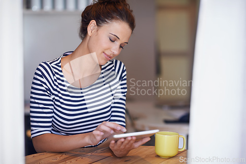 Image of Relax, scroll and woman in home office with tablet, smile and coffee on social media post for business networking. Freelance, remote work and girl at table with digital app for online communication.