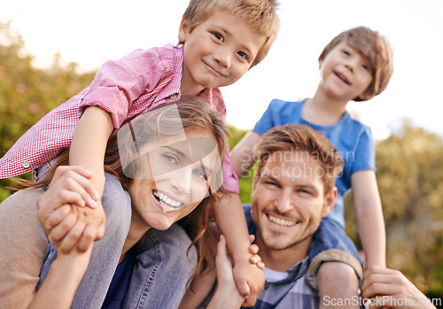 Image of Happy, nature and children on parents shoulders in outdoor park or field for playing together. Smile, bonding and portrait of young mother and father carrying boy kids for fun in garden in Canada.