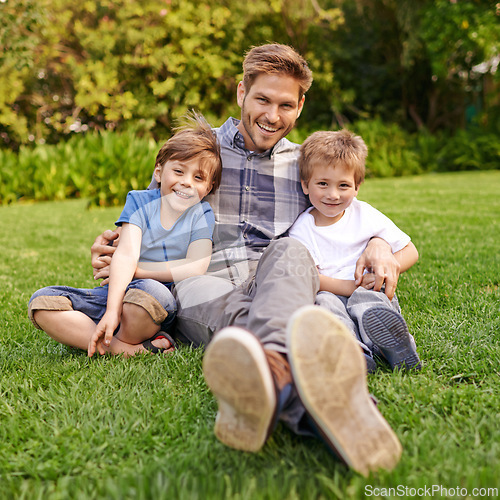 Image of Smile, nature and portrait of children with father relaxing on grass in outdoor park or garden. Happy, family and excited cute boy kids sitting on lawn with young dad for bonding in field together.