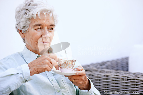 Image of Senior, woman and thinking with cup for retirement, relaxing on patio in peace enjoying wellness retreat and pension. Elderly person, plan activities and drinking tea with reflection and nostalgia