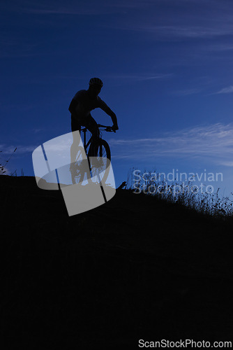 Image of Cyclist, silhouette and bicycle ride at night, hill and mountain biking in countryside. Person, freedom and sky mockup for fitness or exercise, hobby and sports for outdoor adventure and cycling