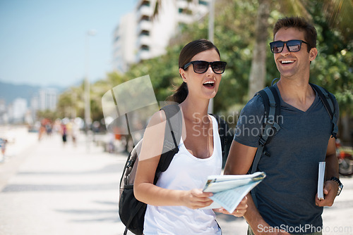 Image of Couple, map and happy at beach in summer, thinking or excited with search for direction on vacation. Woman, man and guide at location, landmark or travel for memory by sea with smile on road in Italy