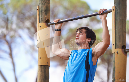 Image of Park, fitness and man on pull up bar with exercise for morning training, health and muscle building in San Francisco. Trees, nature and person with workout for energy, performance and healthy body
