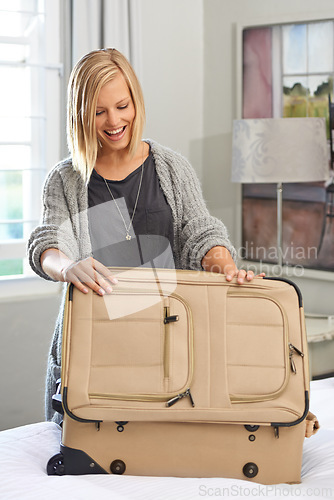 Image of Bedroom, smile and woman packing a suitcase for vacation, holiday or planning to travel. Home, happy person and luggage for trip preparation, journey and getting ready for tourism with bag on bed