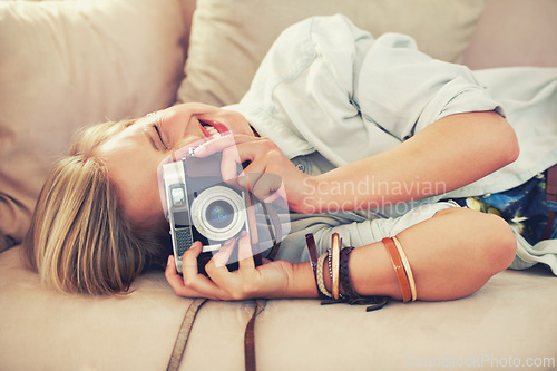 Image of Woman, camera and couch for retro, photography and fashion in casual outfit for hobby at home. Analog, lens or female photographer in trendy, creative and clothes for relax, shoot and freelance